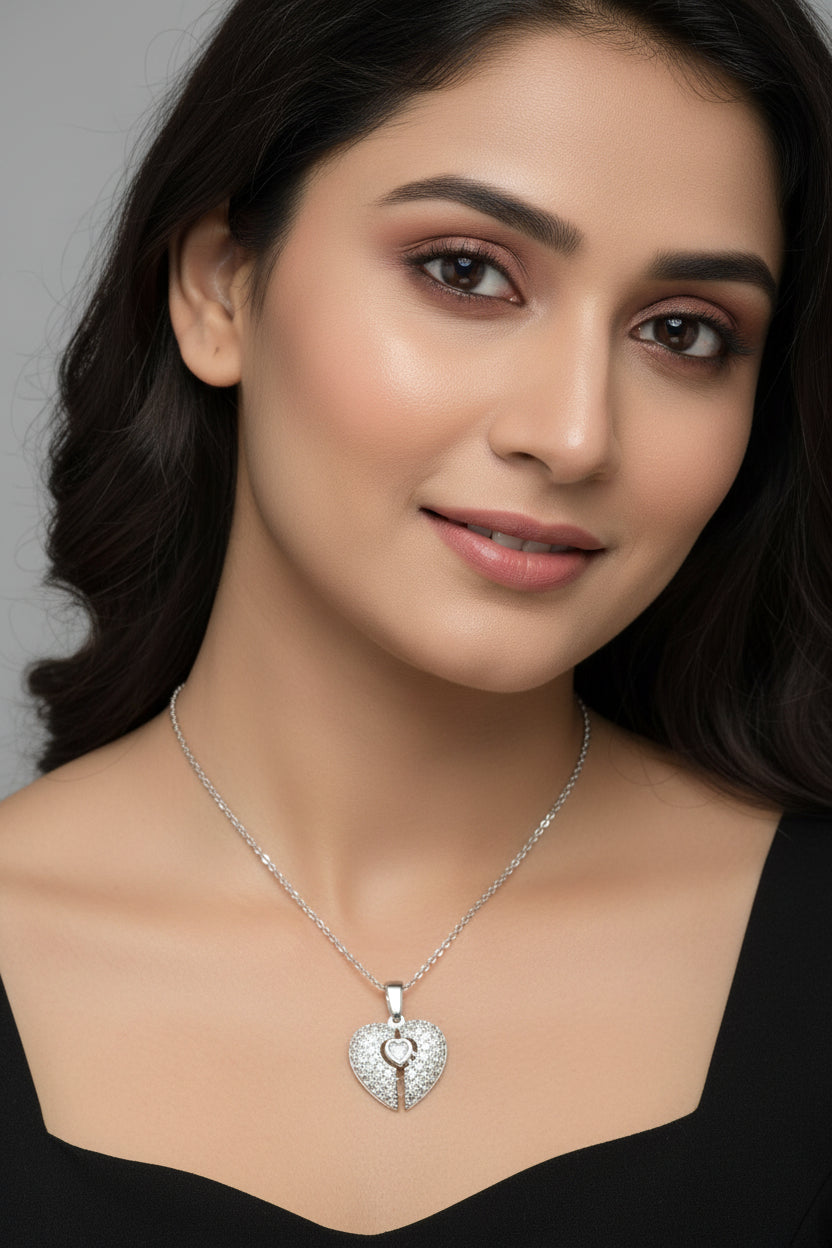 Yoniq.woman silver-tone heart pendant necklace featuring a split-heart design with shimmering cubic zirconia stones.