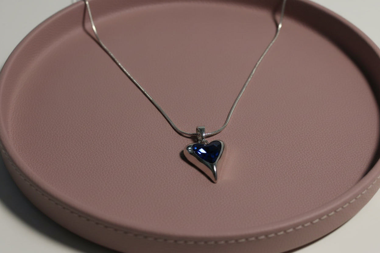 Yoniq.woman silver-tone heart pendant necklace with a polished finish on a delicate chain against a white background.