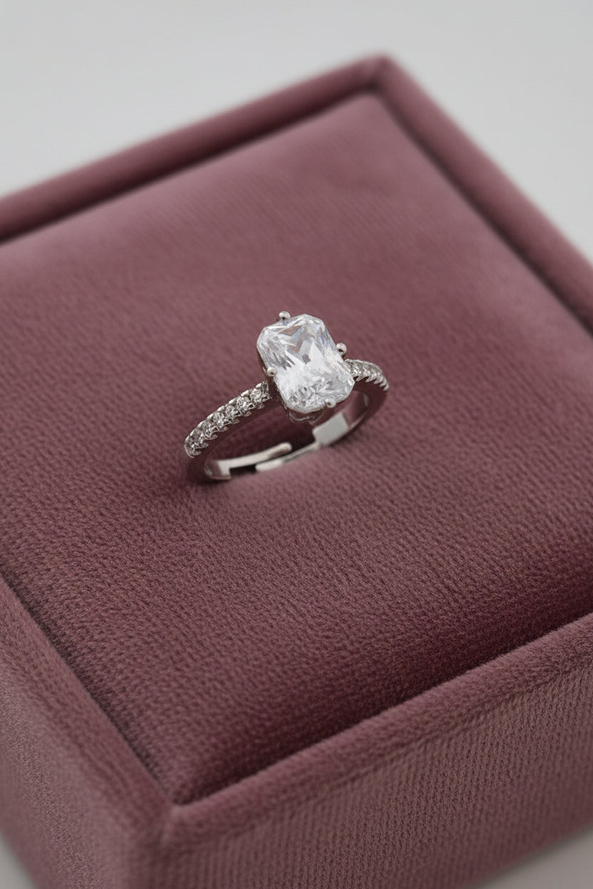 Yoniq.woman silver-tone adjustable ring featuring a radiant-cut cubic zirconia stone and pavé band details.