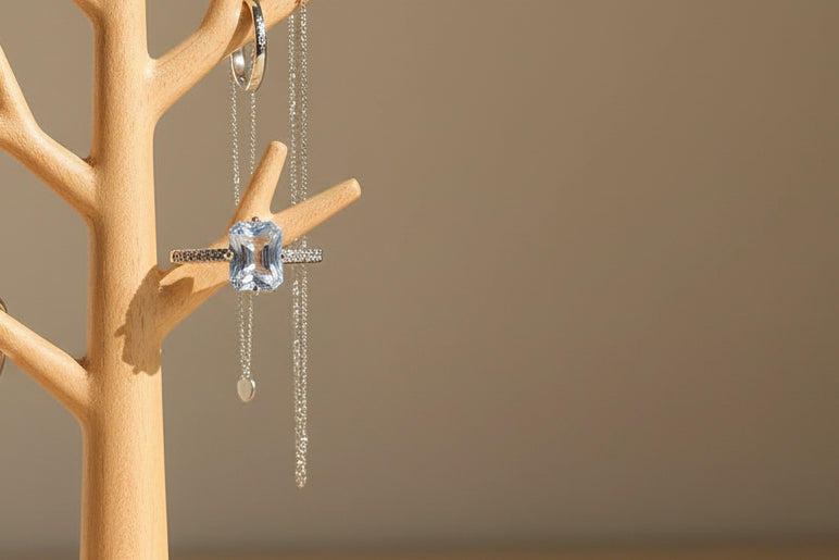 Yoniq.woman silver-tone adjustable ring with a radiant-cut cubic zirconia stone and pavé band on a dark surface.