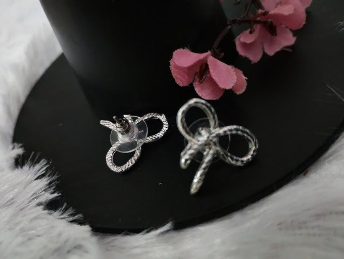Yoniq.woman silver-tone bow stud earrings with a textured ribbon design and secure post-back closure.