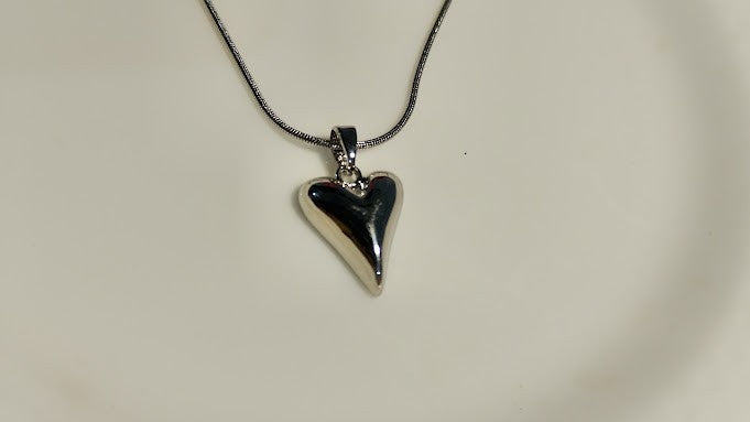 Yoniq.woman silver-tone heart pendant necklace with a polished finish on a delicate snake chain