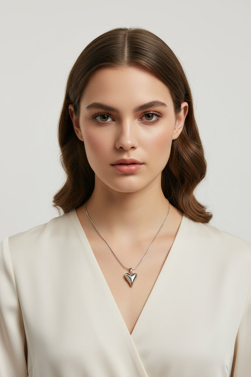 Yoniq.woman silver-tone heart pendant necklace with a polished finish on a delicate chain against a white background