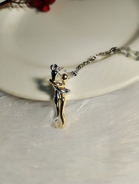 Yoniq.woman two-tone gold and silver intertwined figure pendant necklace on a delicate chain
